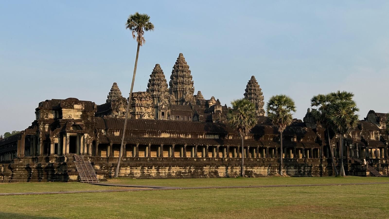 Angkor Wat facade with palm trees