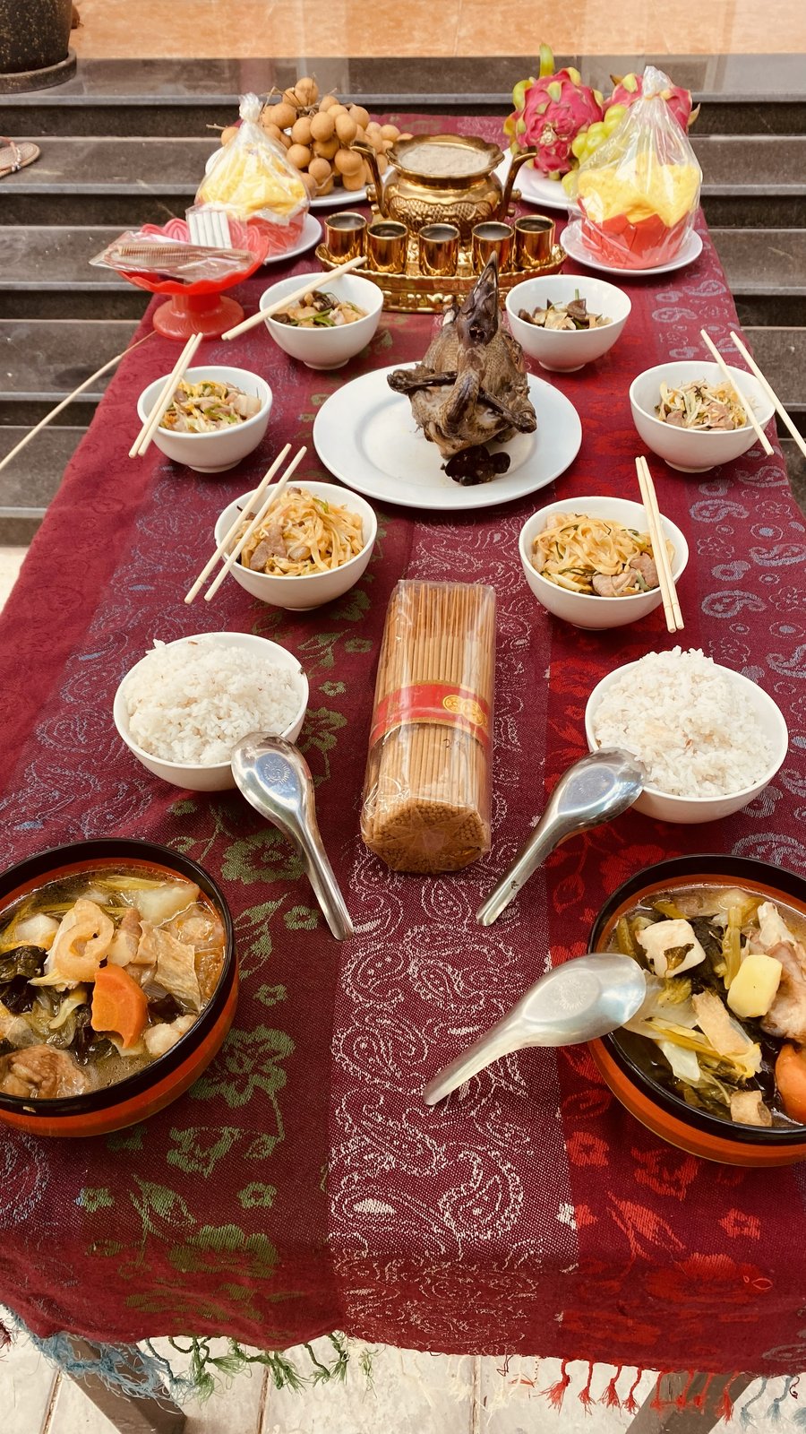 A traditional Khmer feast spread with rice, soup and local fruit